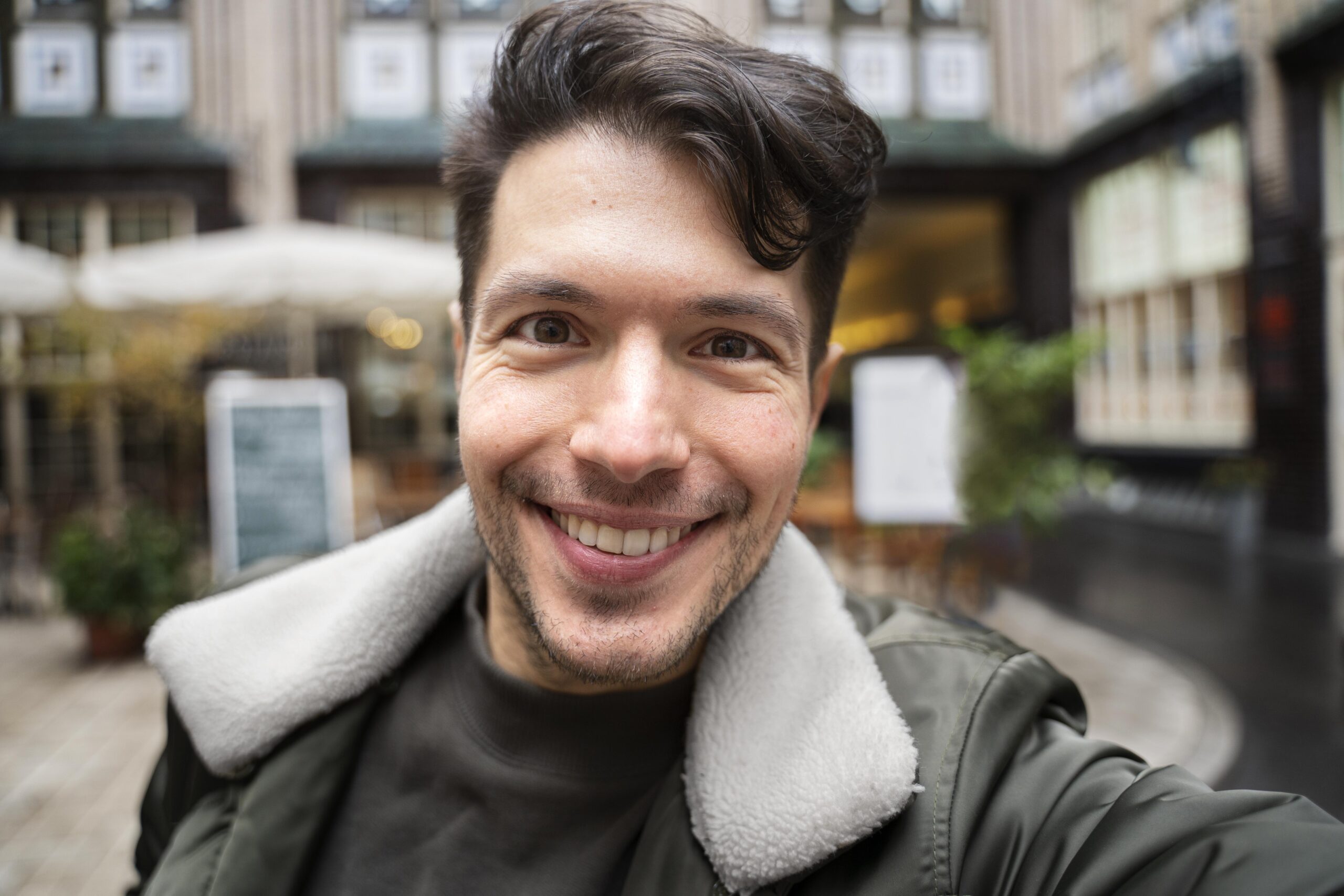 close-up-smiley-man-taking-selfie